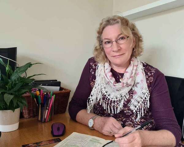 rose working at her desk